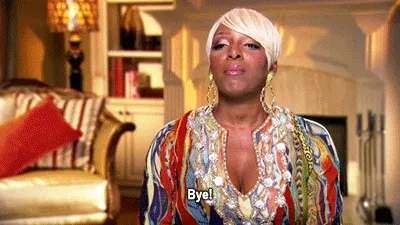 Animated gif of a woman in a colorful sequined top in a living room, subtitle “Bye!”