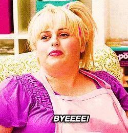 Animated gif of Rebel Wilson as Fat Amy in a pink top, subtitle “BYEEEE!”
