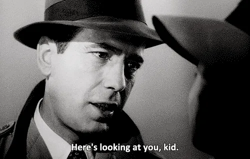 Black-and-white gif of Humphrey Bogart in Casablanca, subtitle “Here’s looking at you, kid.”