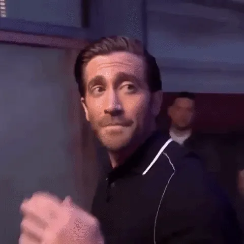 Animated gif of Jake Gyllenhaal glancing back over his shoulder with a smirk as he walks away