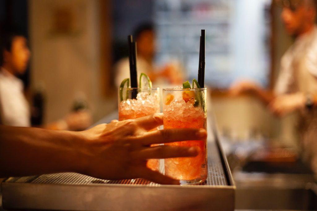 two cocktails at a bar