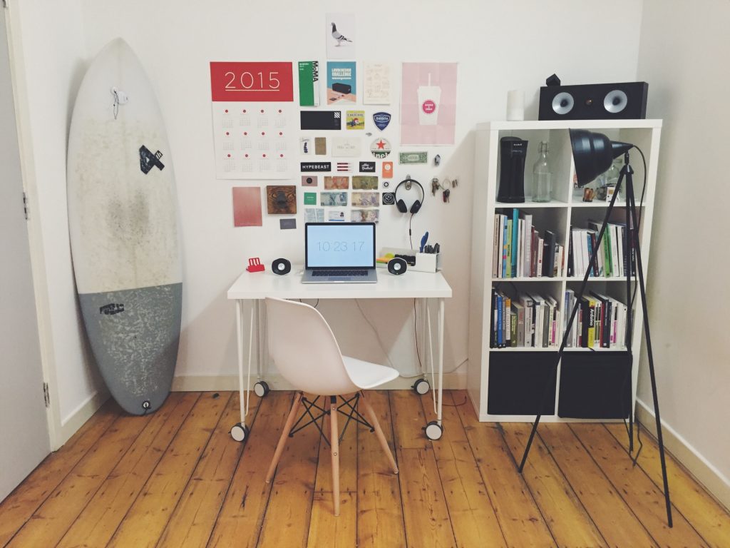 office set up with a lamp and surfboard